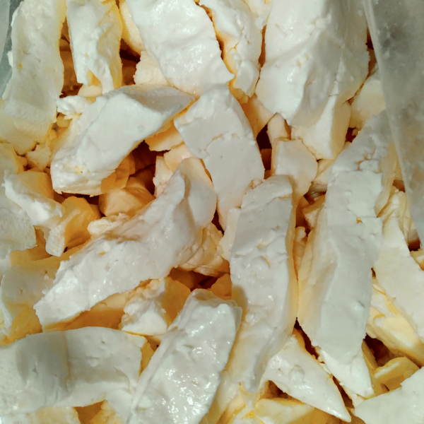 Closeup photo of a batch of fresh and squeaky cheese curd.