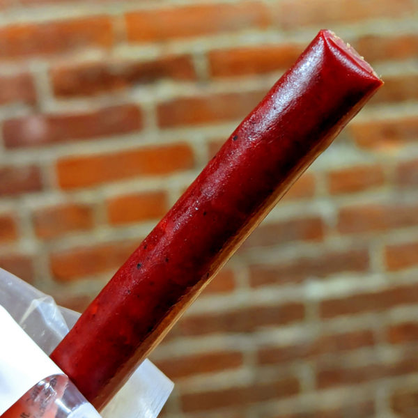A closeup of an unwrapped beef stick.
