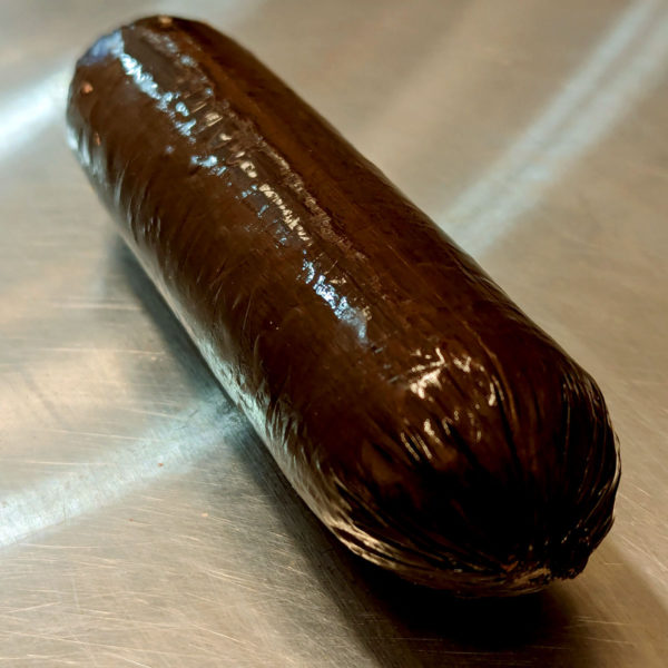 A closeup of unwrapped summer sausage.