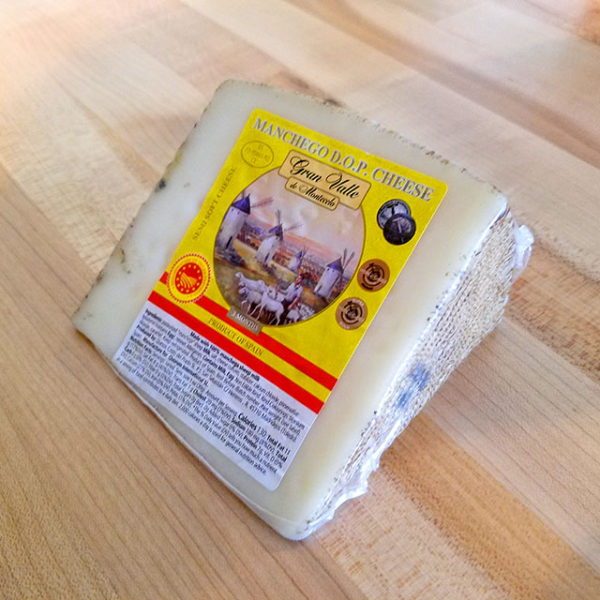 A wedge of Gran Valle Manchego cheese.