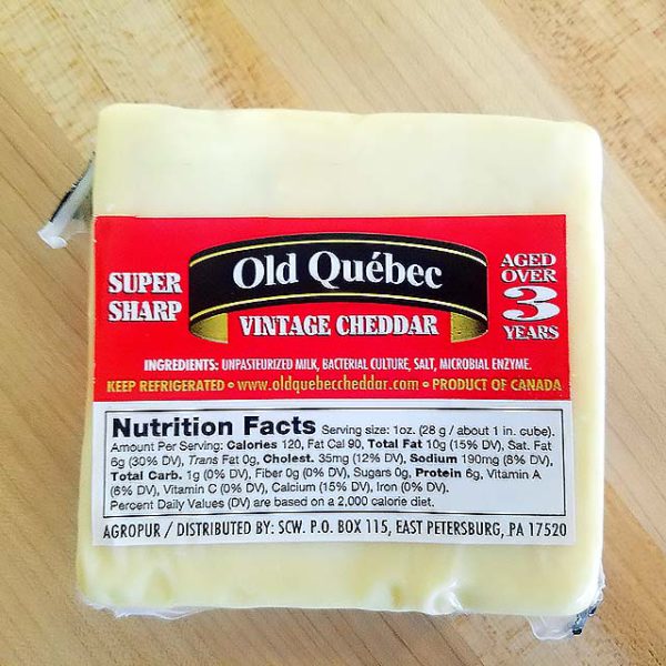 A brick of Old Quebec Vintage Cheddar cheese.