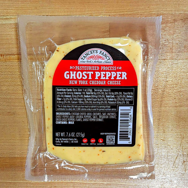 A wedge of Ghost Pepper Aged Sharp Cheddar.