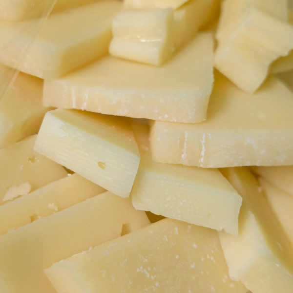 Slices of Classic Asiago cheese on a plate, ready for serving.