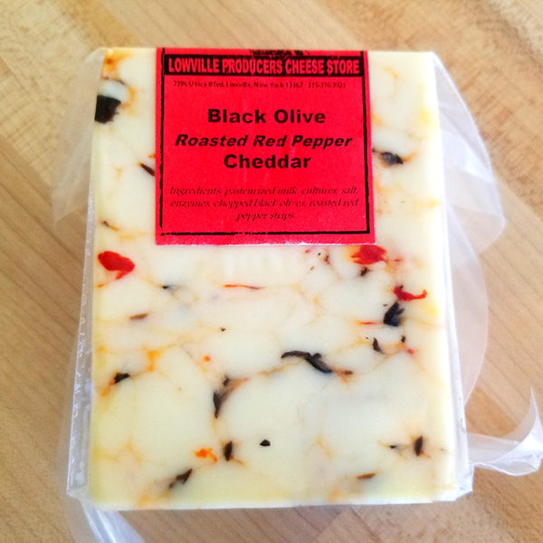 A brick of Black Olive Roasted Red Pepper Cheddar cheese.