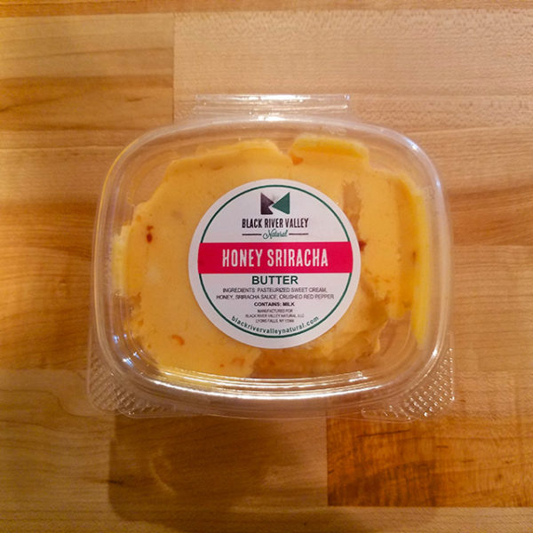 A container of Honey Sriracha Black River Valley Natural Butter.