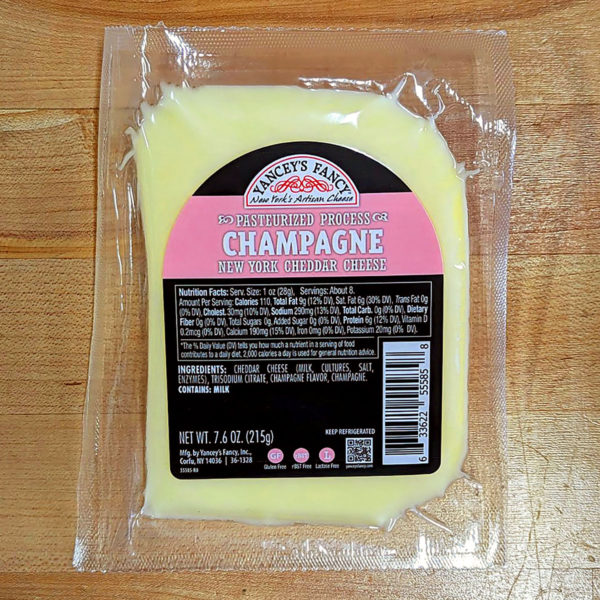 A wedge of Champagne Aged Cheddar cheese.