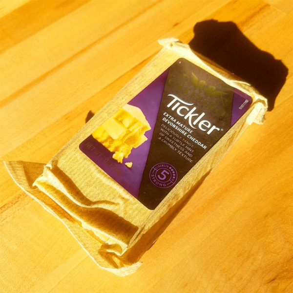 A block of Tickler Extra Mature Devonshire Cheddar cheese.