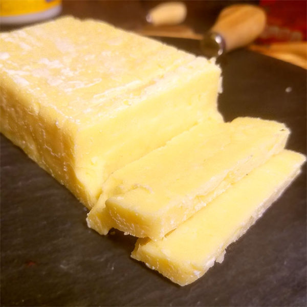 Slices of Tickler Extra Mature Devonshire Cheddar cheese.