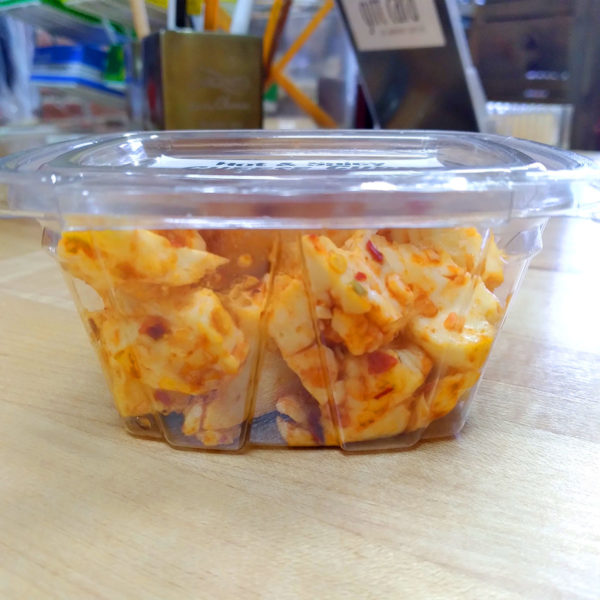 Hot & Spicy cheese curd snack pack, side view.
