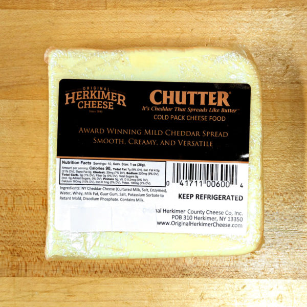 A square block of Chutter cheese spread, in-wrapper.