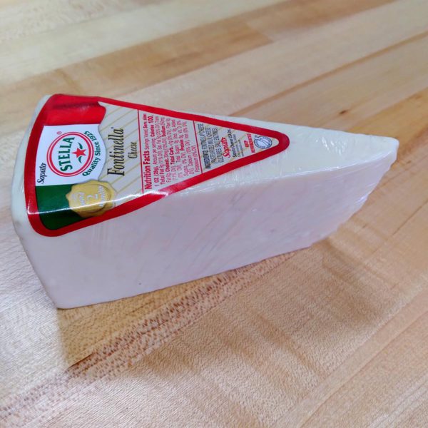Side view of a wedge of Stella Fontinellla cheese.