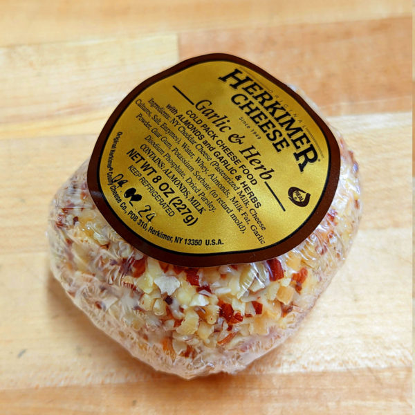 Three-quarters view of Original Herkimer County Cheese Co. Garlic & Herb Cheese Ball, in package.