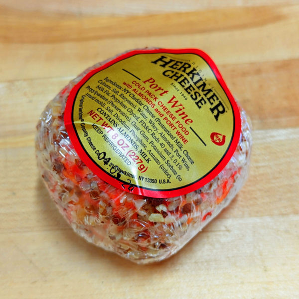 Three-quarters view of Original Herkimer County Cheese Co. Port Wine Cheese Ball, in package.