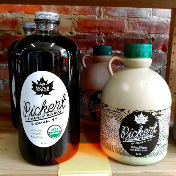 An assortment of Pickert Family Farm maple syrup containers.