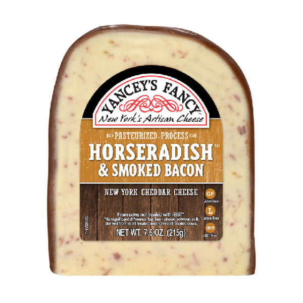 A wedge of Horseradish & Smoked Bacon New York Cheddar cheese.