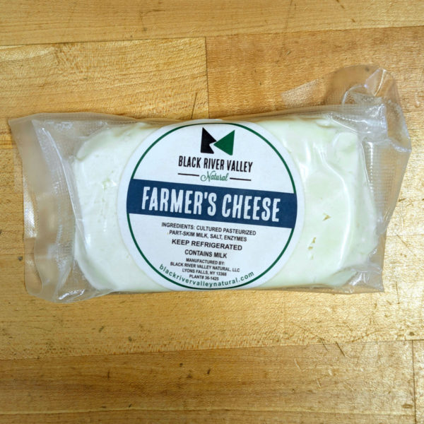 Closeup of a wrapped block of farmer's cheese.