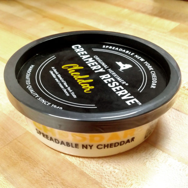A tub of Creamery Reserve Cheddar Cheese Spread.