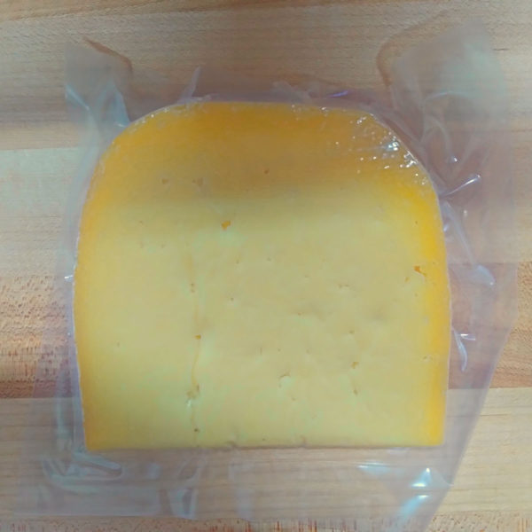 Reverse side of a wedge of BerleBerg cheese.