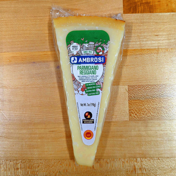 A wedge of Parmigiano Reggiano cheese, wrapped.