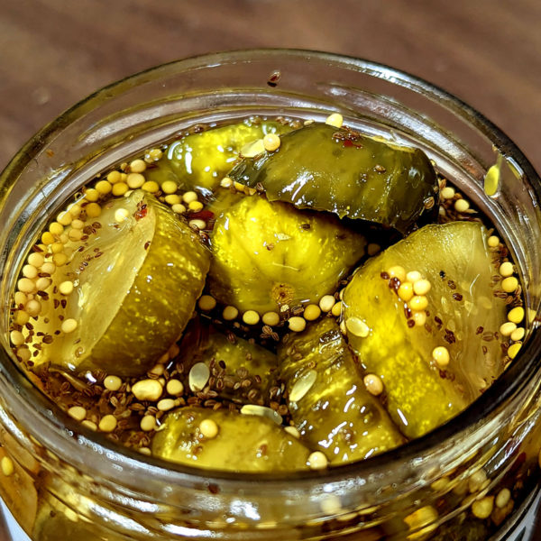 Closeup of an open jar of Fire & Ice Pickles.