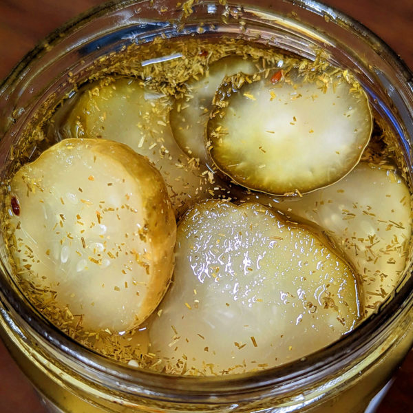 Closeup of an open jar of NY Deli Pickles.