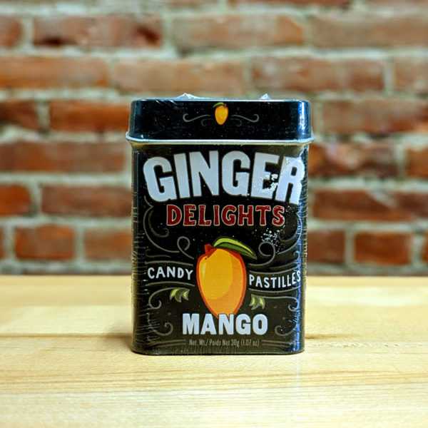 The front of a tin of Mango Ginger Delights candy.