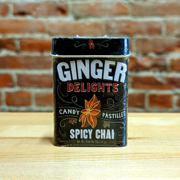 The front of a tin of Spicy Chai Ginger Delights candy.