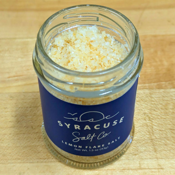 A jar of Lemon Syracuse Salt with the lid off.