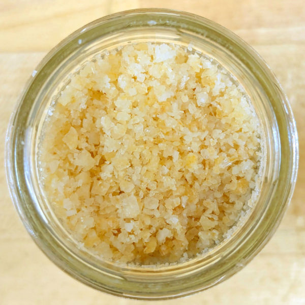 A closeup view of the contents of a jar of Lemon Syracuse Salt.
