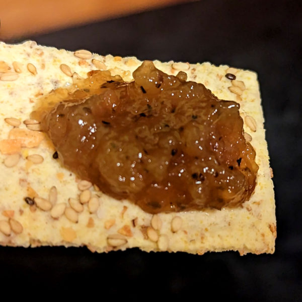 Closeup of Onion Confit on a cracker.
