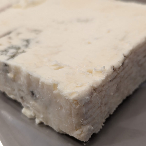 Closeup of a wedge of Gorgonzola Dolce cheese.