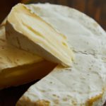 Closeup of Camembert cheese on a wooden table.