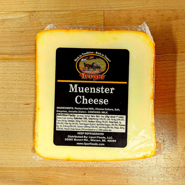 Closeup view of a block of Muenster cheese.