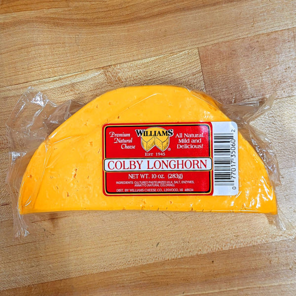 A halfmoon block of Colby Longhorn cheese.