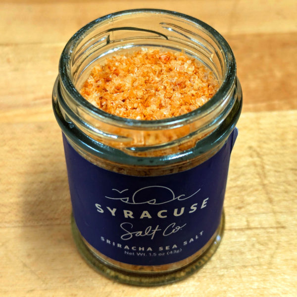 A jar of Sriracha Syracuse Salt with the lid off.