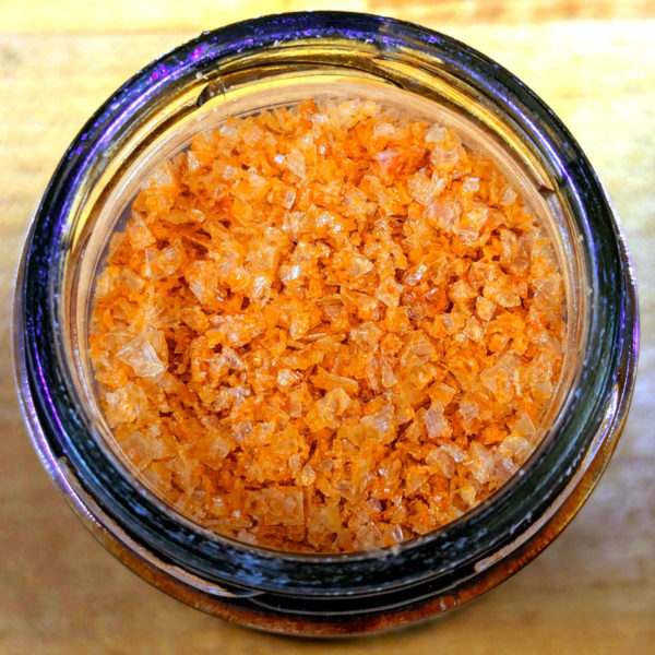 A closeup view of the contents of a jar of Sriracha Syracuse Salt.