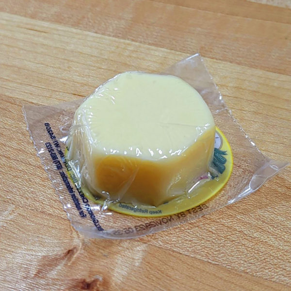 A closeup of BelGioioso Fontina snacking cheese, in the packaging.