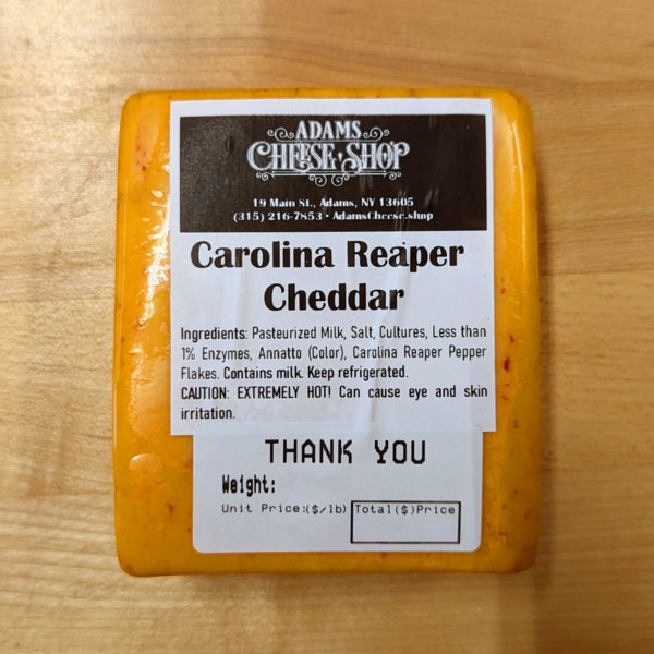 A block of Carolina Reaper Cheddar cheese.
