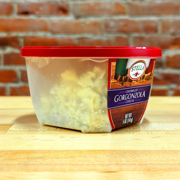 Three-quarters view of a container of Stella Crumbled Gorgonzola cheese.