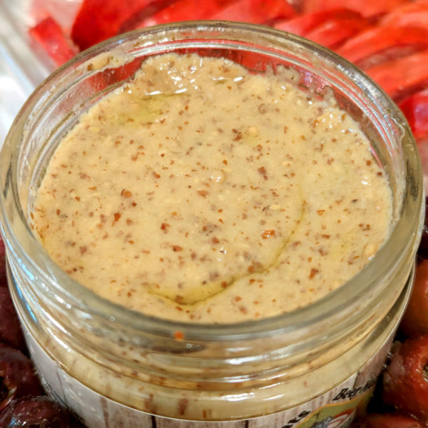 A closeup of an open jar of Brews & Brats mustard.