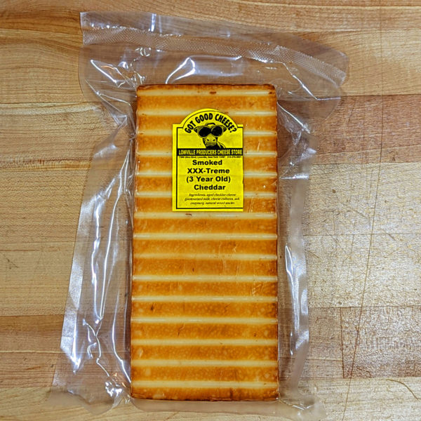 A wrapped block of Smoked 3X-Sharp Cheddar Cheese.