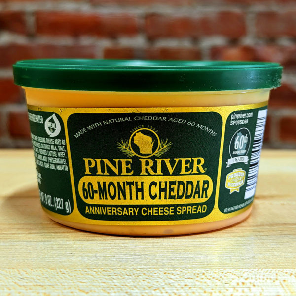 A container of 60 Month Cheddar cheese spread.