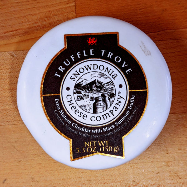 A truckle of Truffle Trove cheese in white wax.