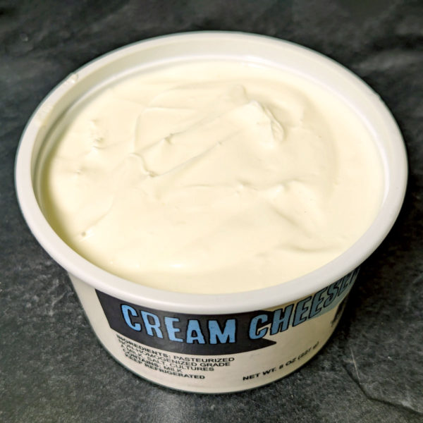 An open tub of Plain Cream Cheese.