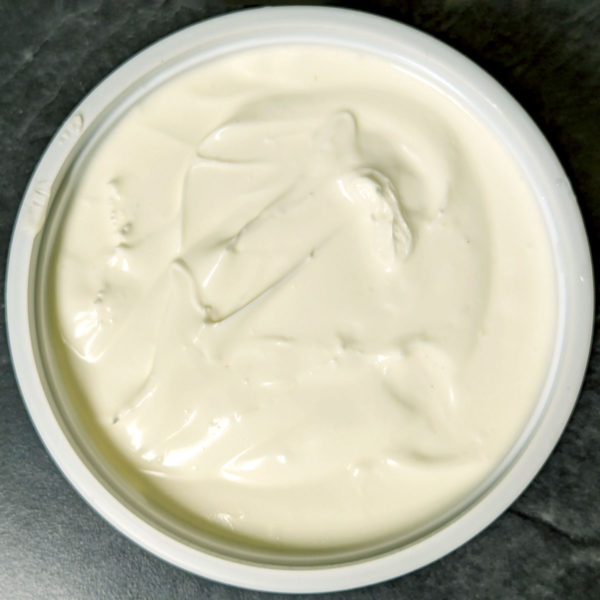 Overhead view of an open tub of Plain Cream Cheese.