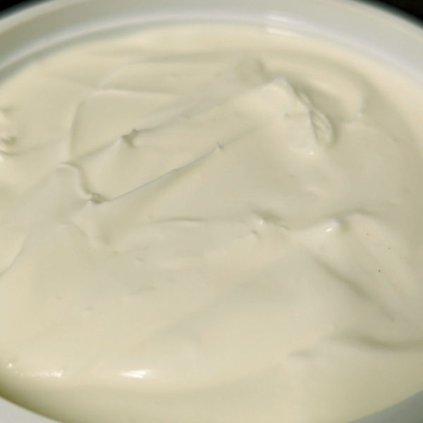 Closeup of an open tub of Plain Cream Cheese.