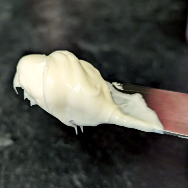 Closeup of Plain Cream Cheese on a knife.