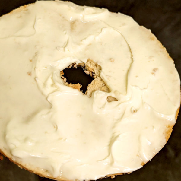 Plain Cream Cheese spread on a bagel.