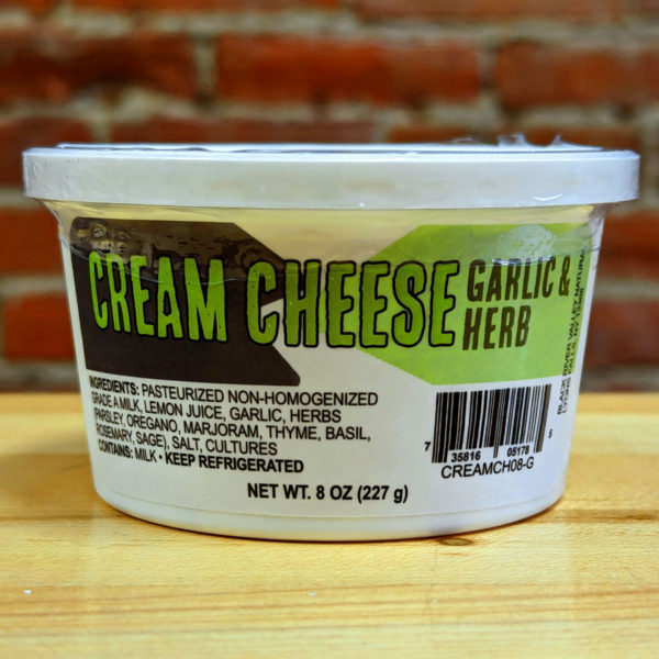 A tub of Garlic & Herb Flavored Cream Cheese.