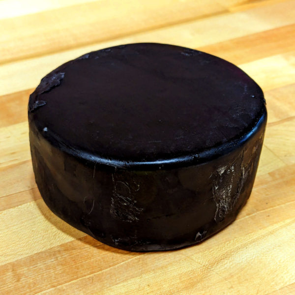 2 lb. Wax Dipped Sharp Cheddar Cheese Wheel, without label.